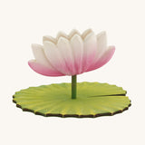 A Hand Crafted and Hand Painted Large Bumbu Wooden Lotus Flower. The figure has a pink and white Lotus Flower with a green stalk and green base, which has been handmade and hand painted, pictured on a plain background 