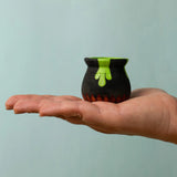 Bumbu handcrafted wooden black magic cauldron decorative figure on a adult hand showing scale