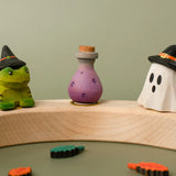 Bumbu handcrafted wooden magic potion decorative figure displayed on a celebration ring in between a spell frog and wizard ghost figure