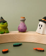 Bumbu handcrafted wooden magic potion decorative figure displayed on a celebration ring in between a spell frog and wizard ghost figure