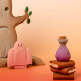 Bumbu handcrafted wooden magic purple potion decorative figure in a halloween scene including a spooky tree, ghost and book figures