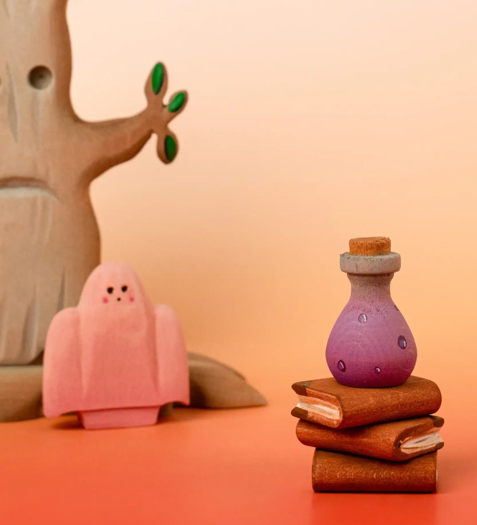 Bumbu handcrafted wooden magic purple potion decorative figure in a halloween scene including a spooky tree, ghost and book figures