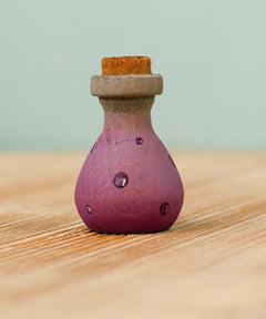 Bumbu handcrafted wooden magic potion decorative figure. A purple flask with painted detail