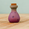 Bumbu handcrafted wooden magic potion decorative figure. A purple flask with painted detail