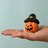 Bumbu handcrafted wooden magic pumpkin decorative figure on a adult hand showing scale