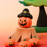 Bumbu handcrafted wooden magic pumpkin decorative figure displayed with smaller pumpkin and tree stump figures