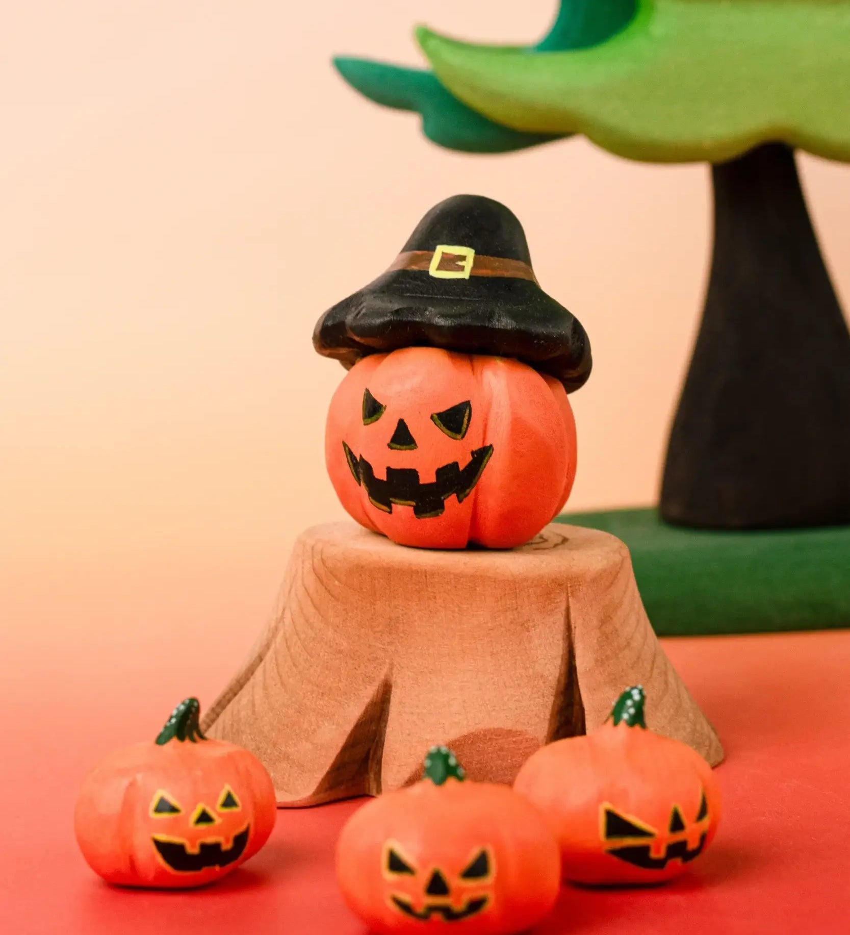 Bumbu handcrafted wooden magic pumpkin decorative figure displayed with smaller pumpkin and tree stump figures