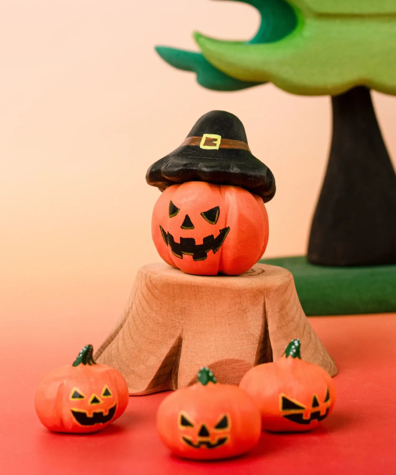 Bumbu handcrafted wooden magic pumpkin decorative figure displayed with smaller pumpkin and tree stump figures
