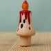 Bumbu handcrafted wooden magic candle with a friendly face and painted red dripping wax
