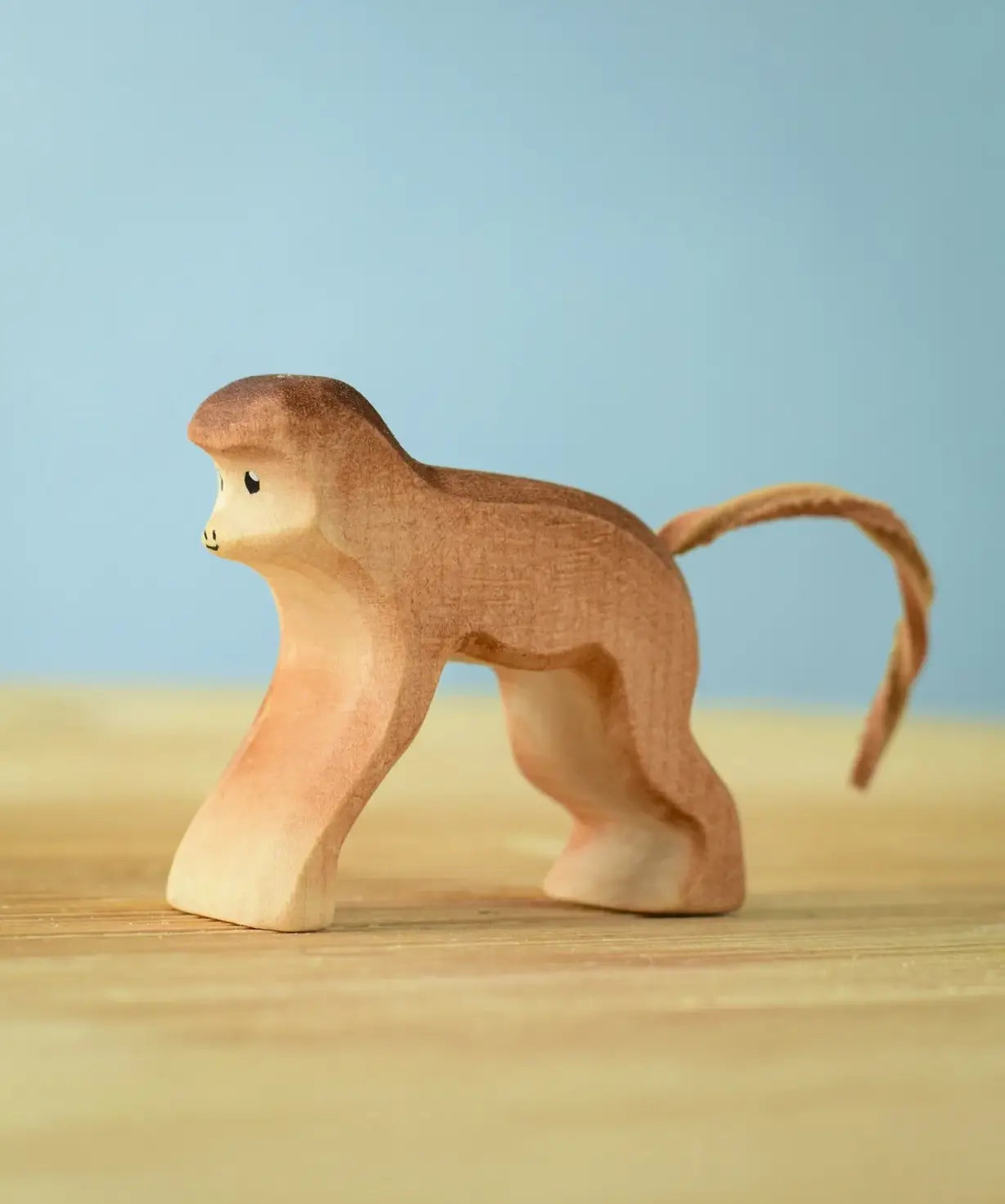 Bumbu toys handcrafted wooden brown standing monkey figure with a cord tail