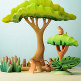A playscene using Bumbu toys handcrafted wooden trees, grass and monkey figures
