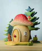 The Bumbu toadstool house shown in a small world play scene alongside Bumby trees, flowers and a rabbit.