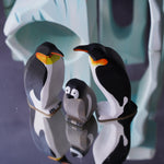 Bumbu handmade wooden penguins and penguin chick stood on a Bumbu ice floe block next to some Papoose felt snowballs