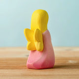 Back of the Bumbu wooden pink fairy figure showing yellow wings detail