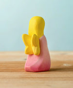 Back of the Bumbu wooden pink fairy figure showing yellow wings detail
