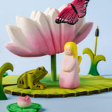 A pond playscene showing a Bumbu pink fairy figure, frog, butterfly, lily and lotus flower figures