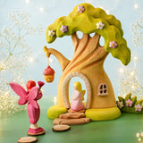 Bumbu handcrafted wooden pink fairy figure standing in the fairy treehouse doorway