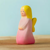 Bumbu handcrafted wooden pink fairy figure with painted yellow hair and facial features