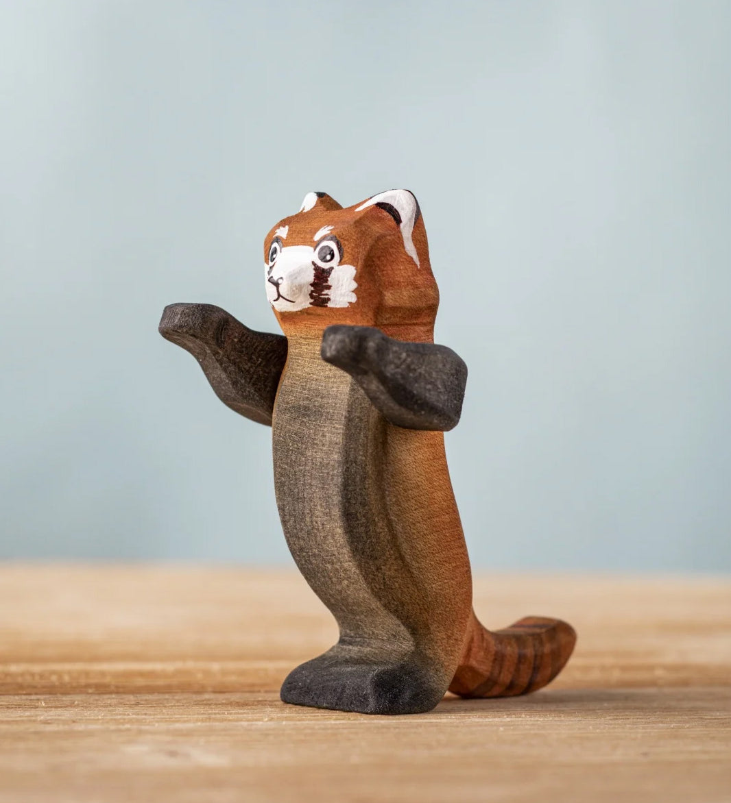 Bumbu wooden playful red panda figure standing on a wooden board