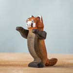 Bumbu wooden playful red panda figure standing on a wooden board