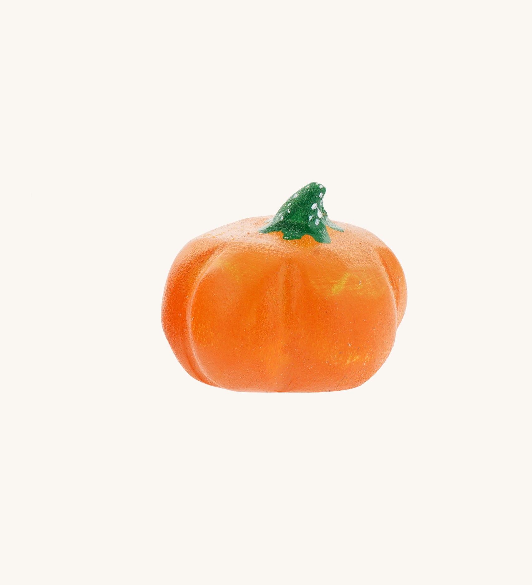 A small Bumbu hand carved wooden pumpkin toy. These expertly hand crafted items are part of a large range of wooden toys available here at Babipur. 