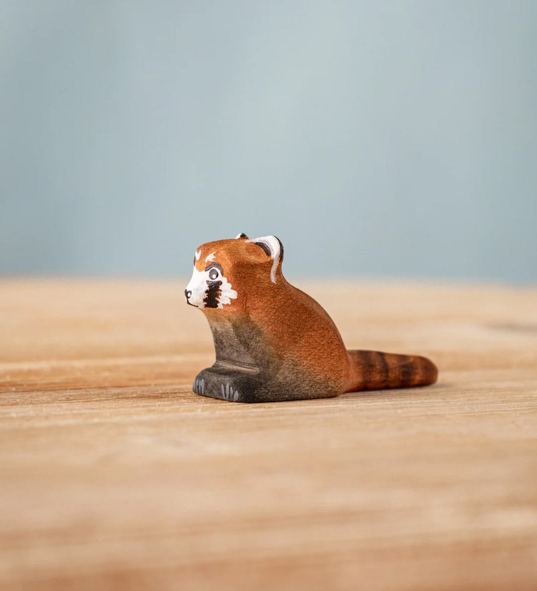Bumbu wooden red panda cub figure on a wooden board