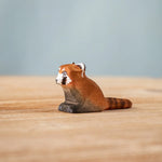 Bumbu wooden red panda cub figure on a wooden board