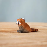 Bumbu wooden red panda cub figure on a wooden board