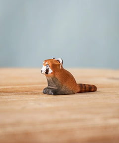 Bumbu wooden red panda cub figure on a wooden board