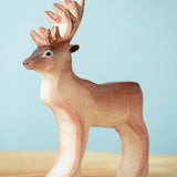 Bumbu Toys Reindeer figure placed on a wooden surface. 