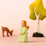 Bumbu wooden sage fairy figure with a eating deer and birch tree in the background