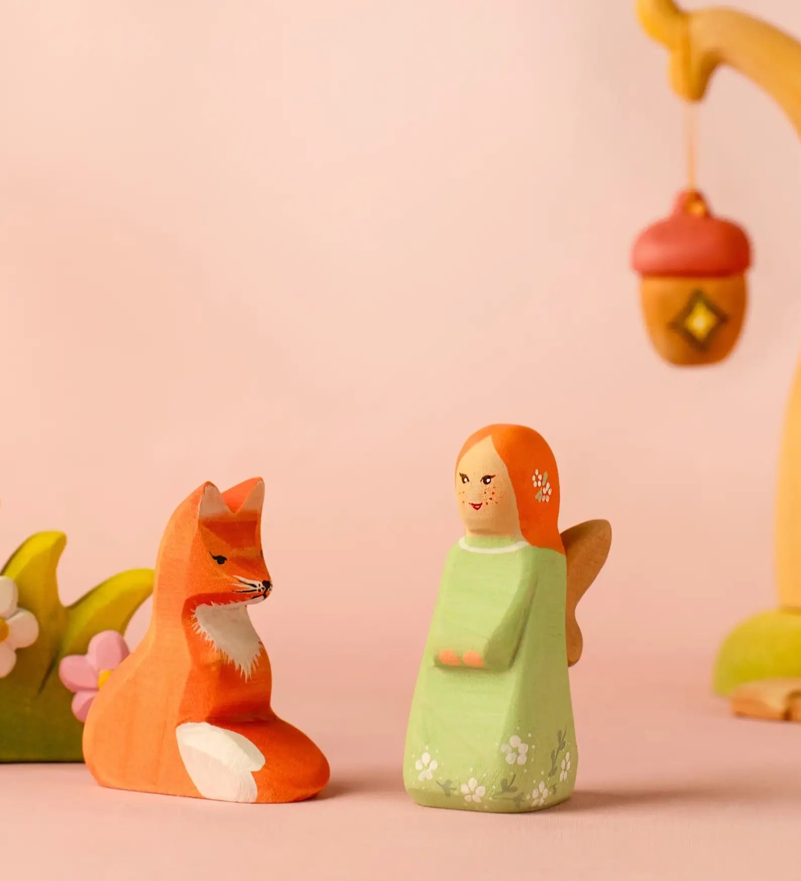 Bumbu wooden sage fairy figure standing next to a sitting fox figure