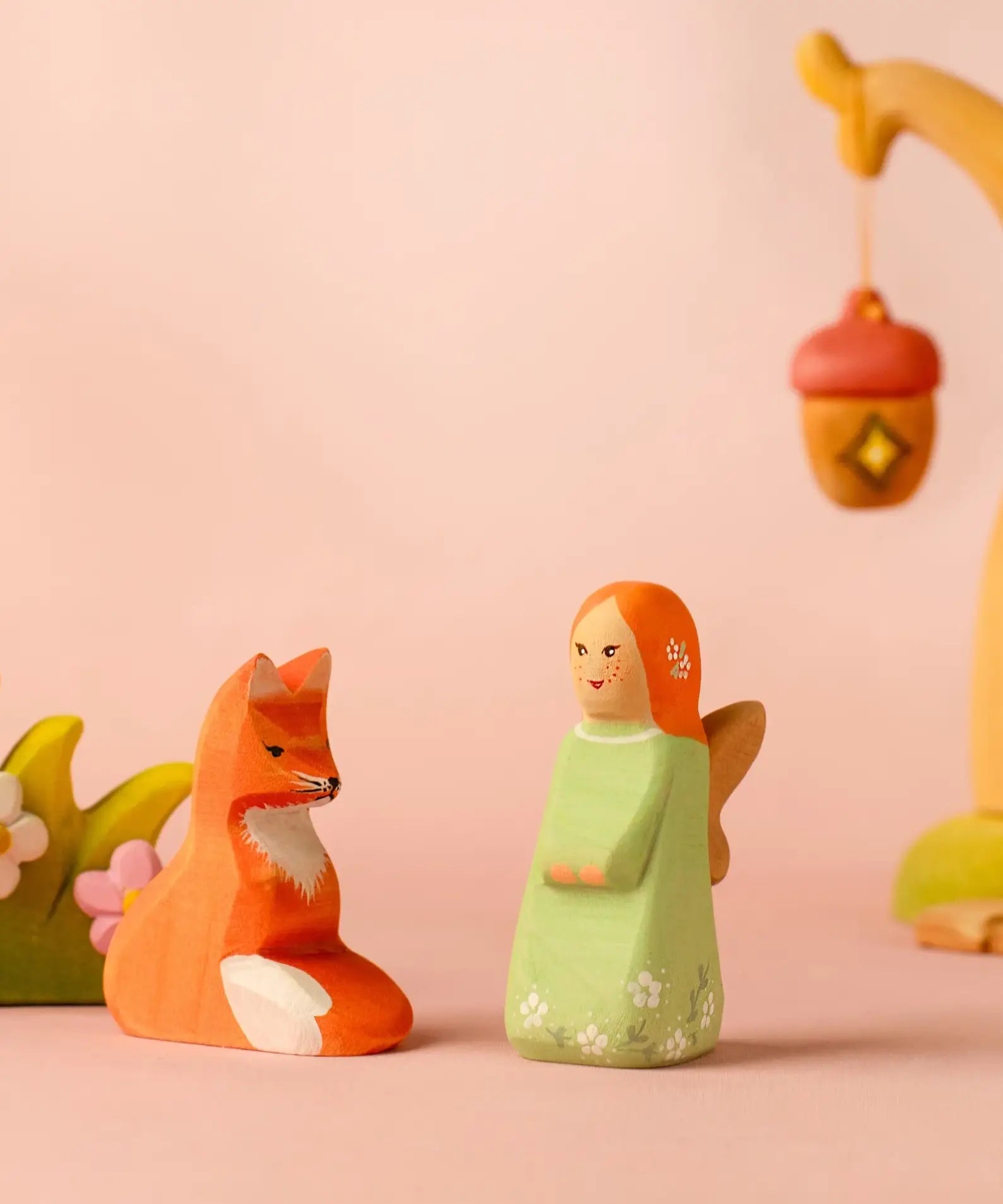 Bumbu wooden sage fairy figure standing next to a sitting fox figure