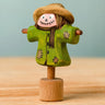 Bumbu handcrafted wooden scarecrow decorative figure with painted detail, wearing a brown hat and standing on a celebration ring peg base