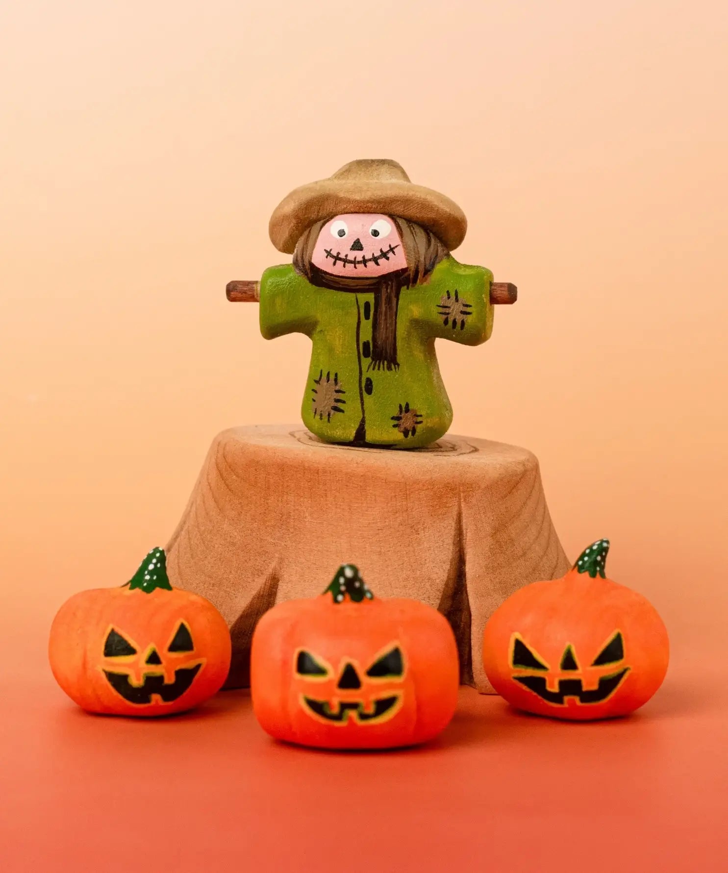 Bumbu handcrafted wooden scarecrow decorative figure in a spooky display including a tree stump and mini pumpkin figures