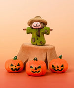 Bumbu handcrafted wooden scarecrow decorative figure in a spooky display including a tree stump and mini pumpkin figures