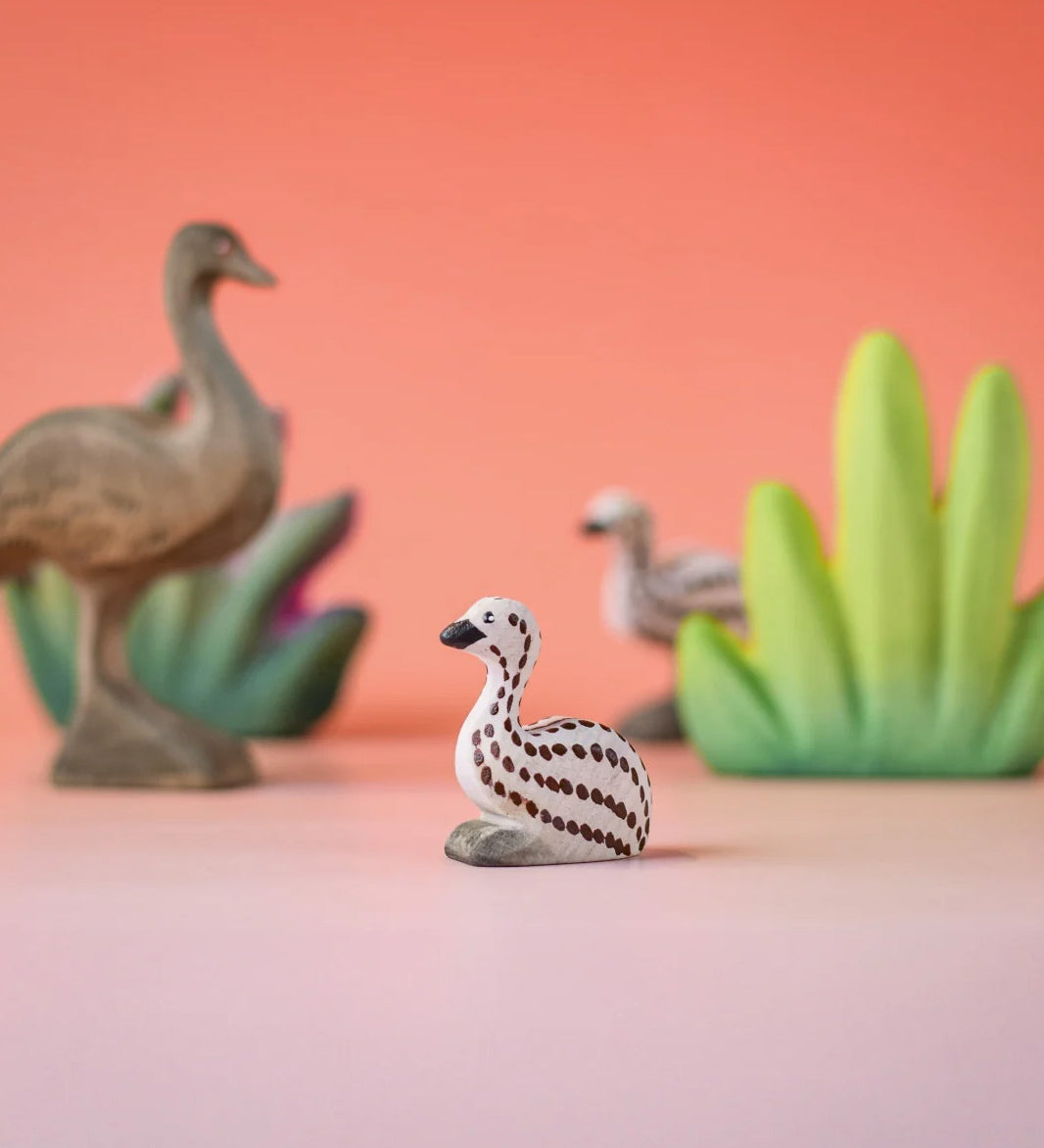 Bumbu wooden sitting emu chick in a nature play scene. 