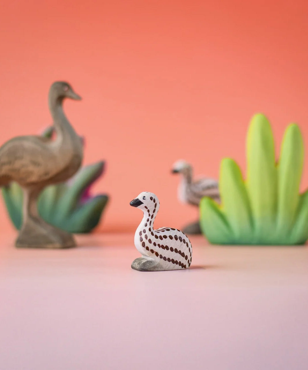 Bumbu wooden sitting emu chick in a nature play scene. 