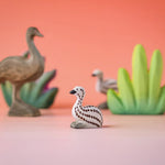 Bumbu wooden sitting emu chick in a nature play scene. 