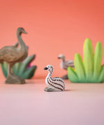 Bumbu wooden sitting emu chick in a nature play scene. 