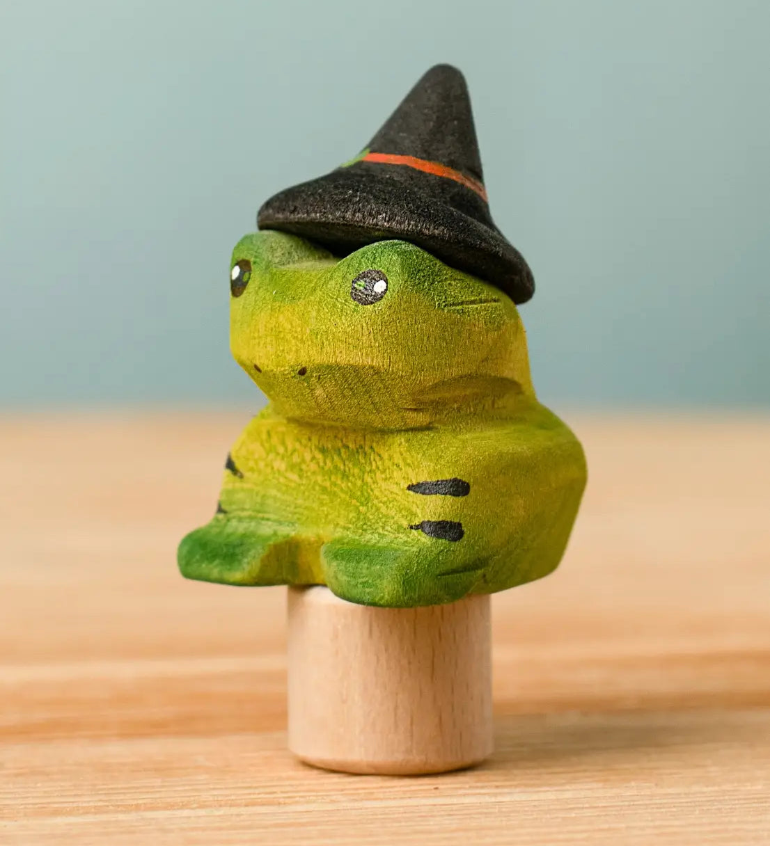 Bumbu handcrafted wooden magical frog decorative figure wearing a witch hat for Halloween decoration.