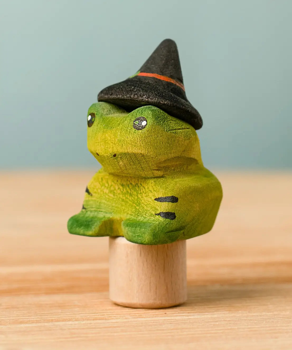 Bumbu handcrafted wooden magical frog decorative figure wearing a witch hat for Halloween decoration.