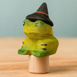 Bumbu handcrafted wooden magical frog decorative figure wearing a witch hat for Halloween decoration.
