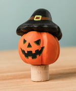 Bumbu handcrafted wooden magic pumpkin decorative figure wearing a black hat.