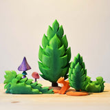 Bumbu wooden shrubs and bushes toy figures placed on a wooden worktop next to the green Thuja tree toy figures. These expertly hand crafted items are part of a large range of wooden toys available here at Babipur. 