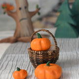 Three Bumbu pumpkins, small, medium and large. The medium pumpkin has been placed in a Kraul basket with the two others placed besides it. 