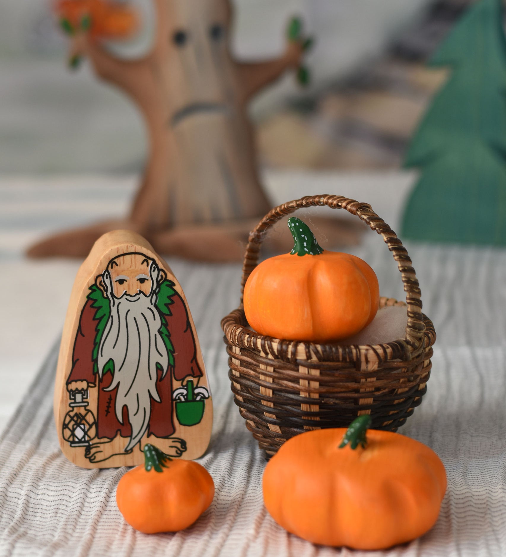 Three Bumbu pumpkins placed in a Kraul basket next to a Lanka Kade hermit figure. 
