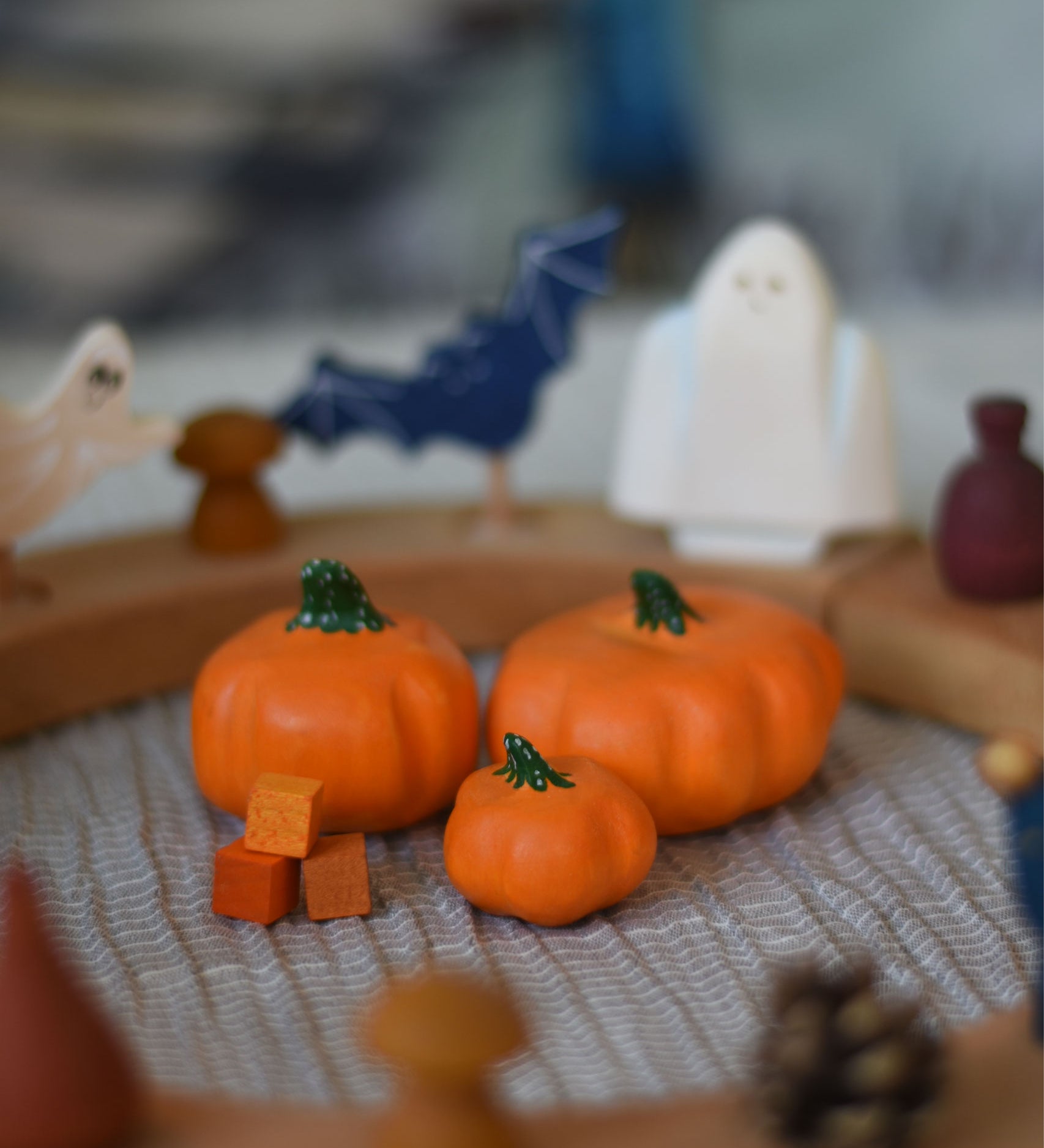 Three Bumbu pumpkins, small, medium and large placed in the centre of a Grimm's celebration ring. 