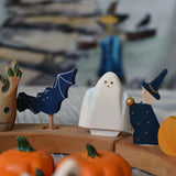 A Bumbu ghost wooden toy figure placed on a Grimm's Halloween themed celebration ring set up. 
