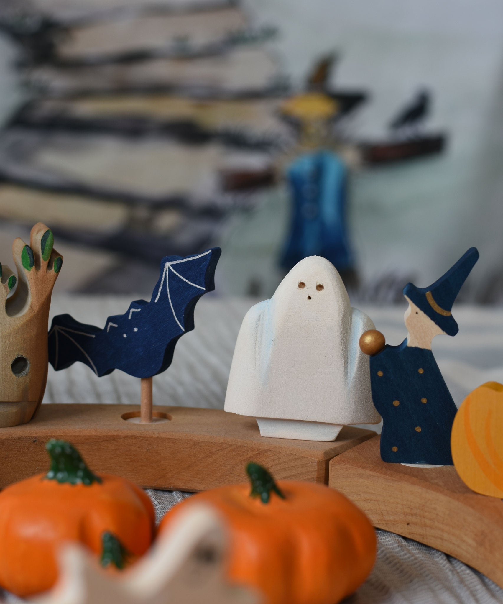 A Bumbu ghost wooden toy figure placed on a Grimm's Halloween themed celebration ring set up. 